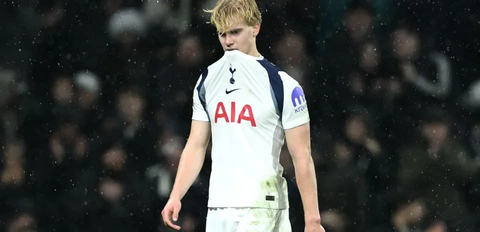 Tottenham player looking down during match in rain