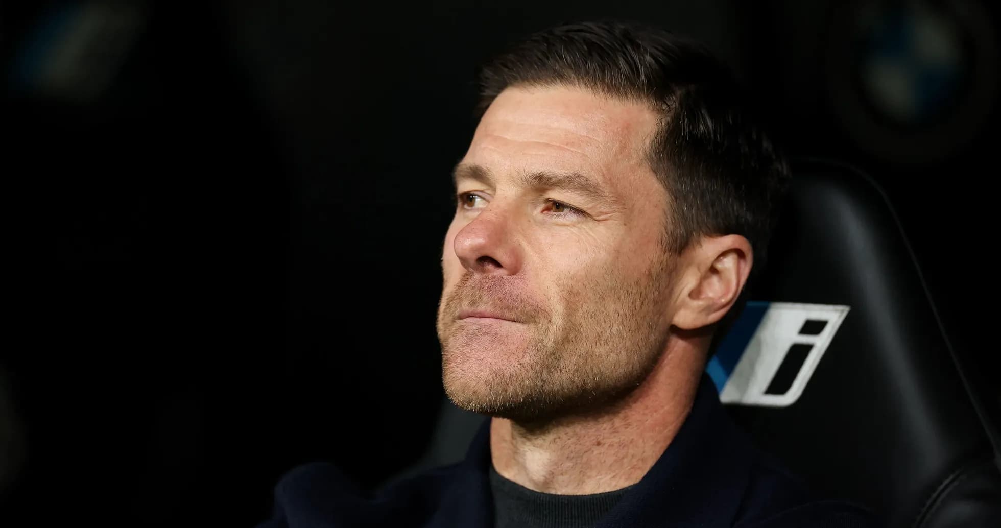Coach sitting on bench during a match