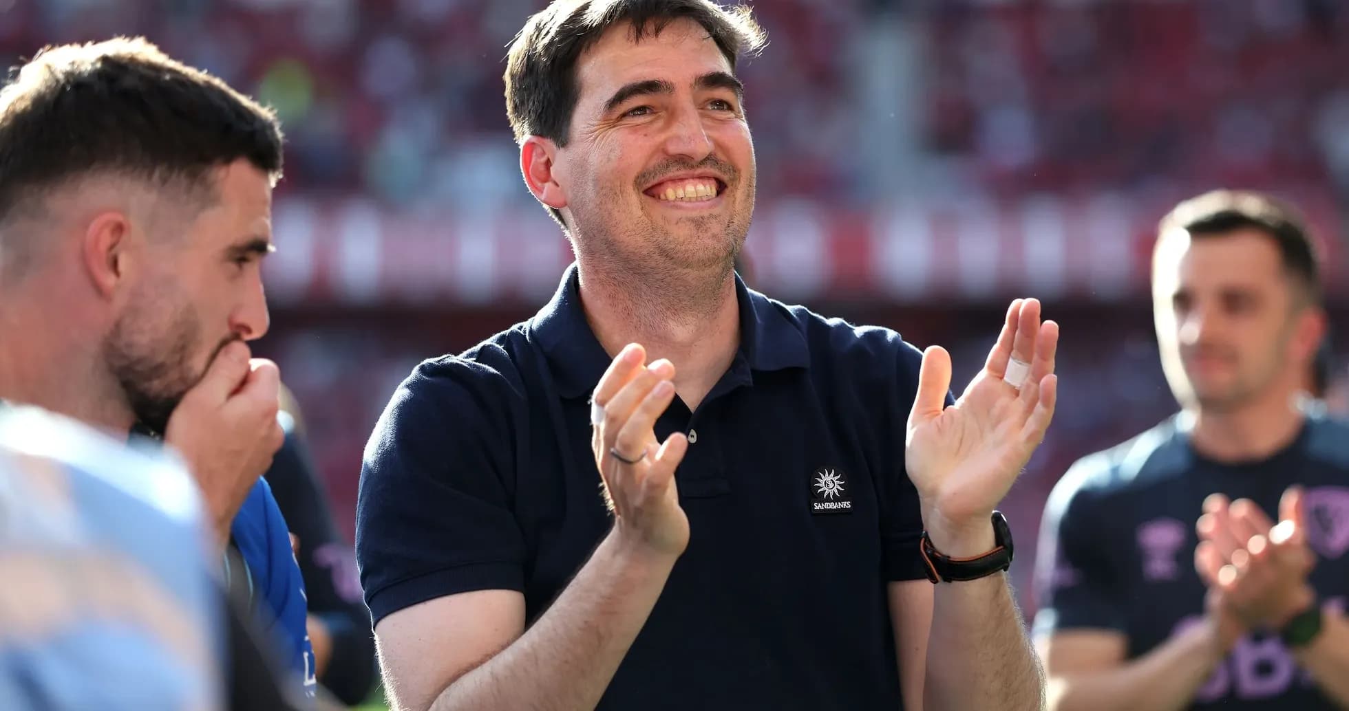 Man applauding with teammates during match celebration