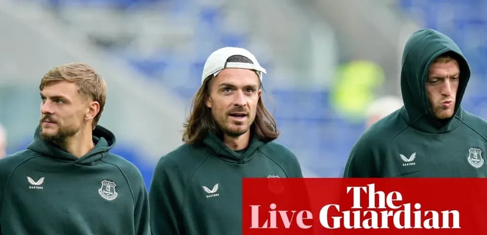 Three players walking in Everton hoodies before match