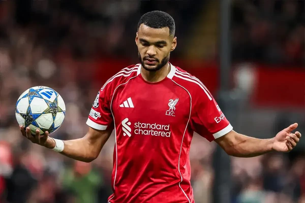 Player in red Liverpool jersey holding a football