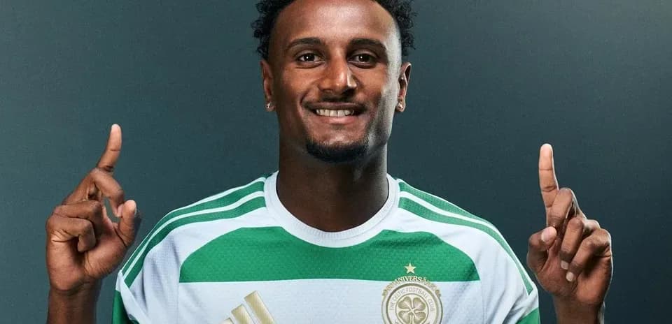 Player in green and white jersey posing for photo