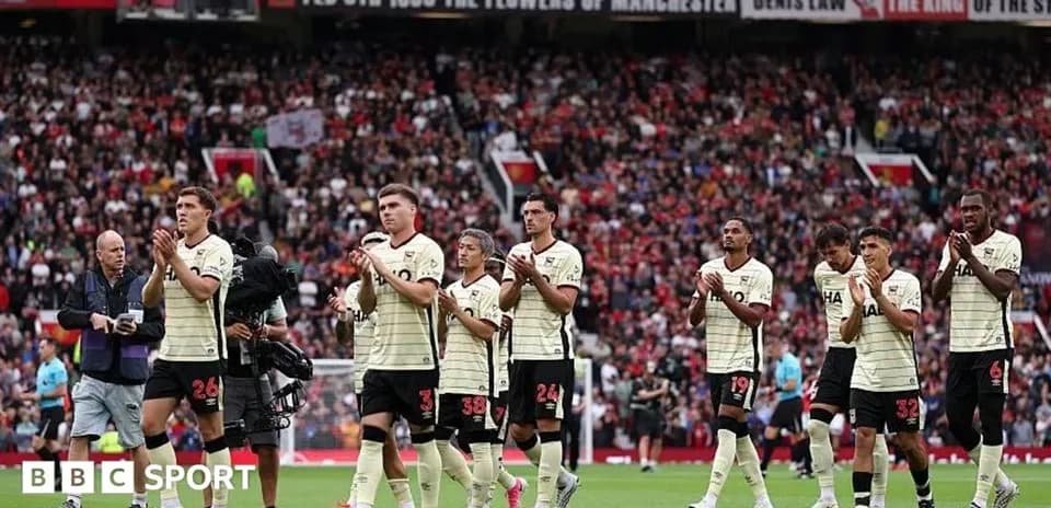 Team applauding fans after match at stadium