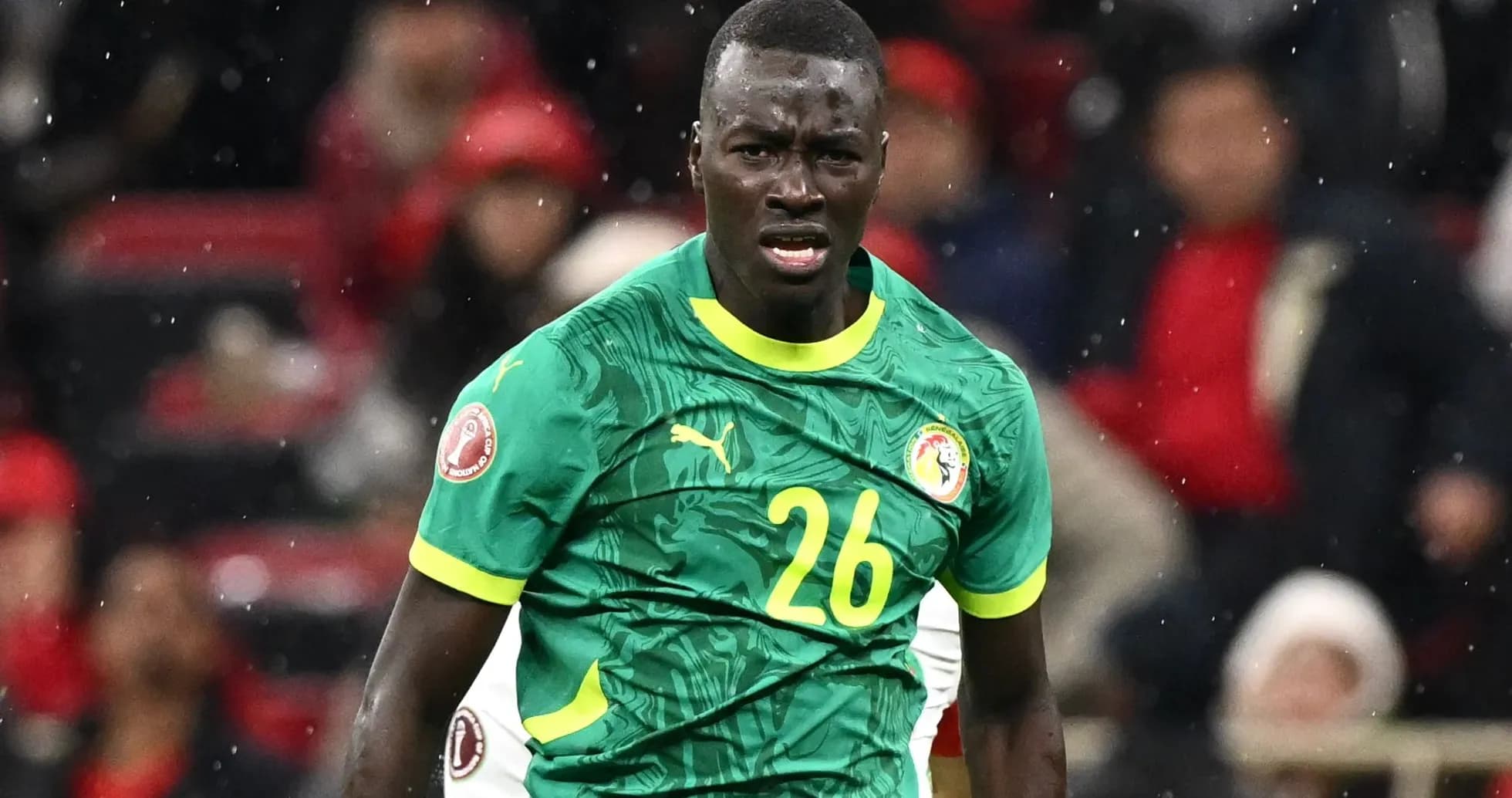 Player in green jersey during a football match