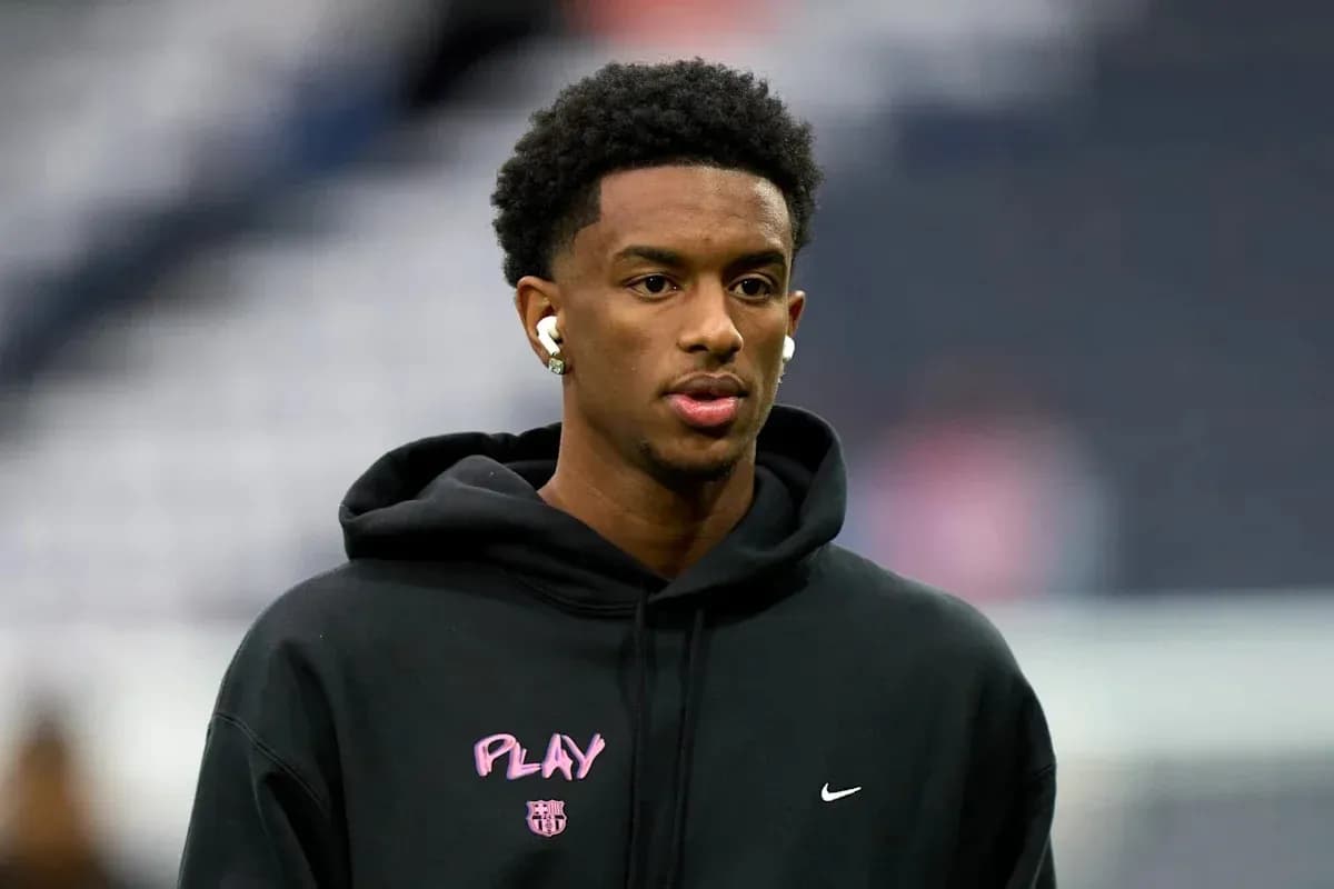 Player wearing earbuds in black hoodie before game