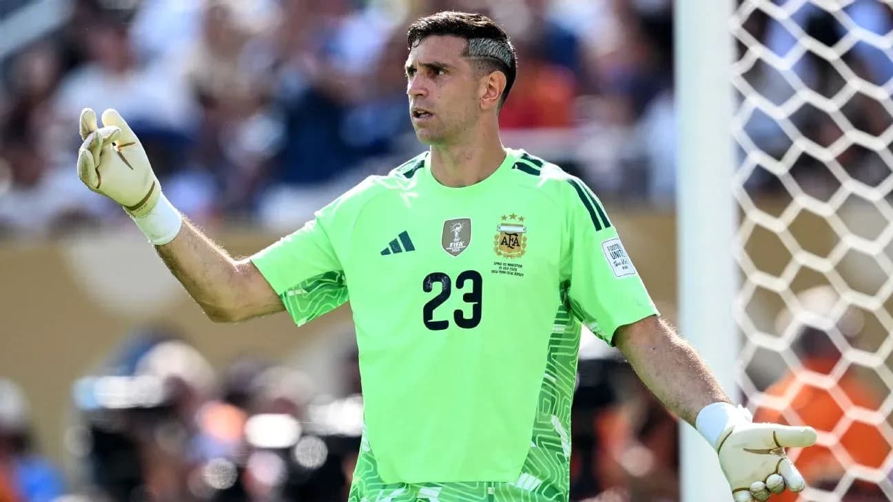 Goalkeeper in green uniform directing play on field