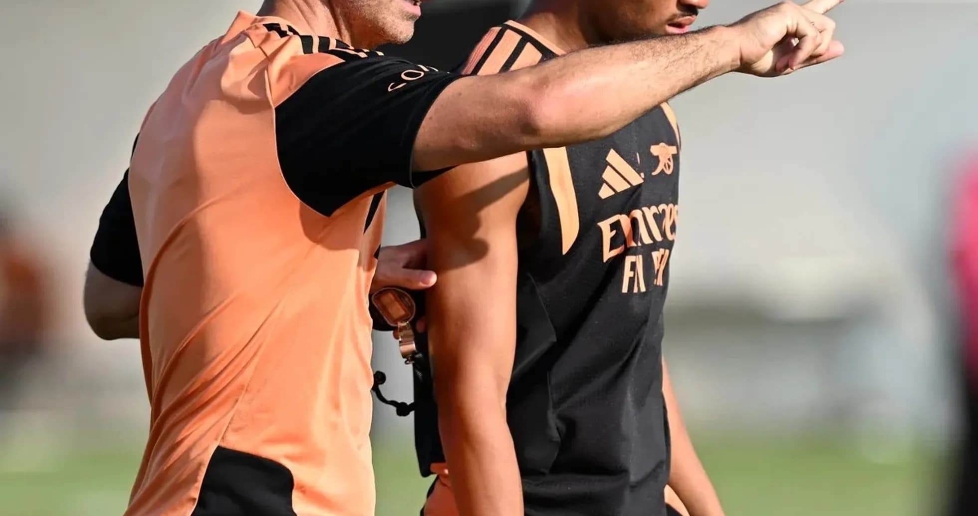 Coach instructing player during training session