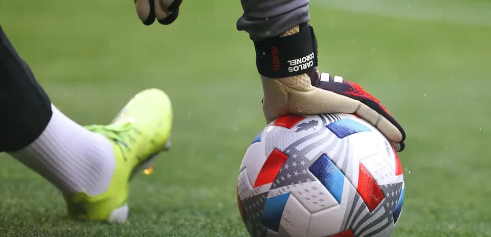 Goalkeeper placing ball on field before kick