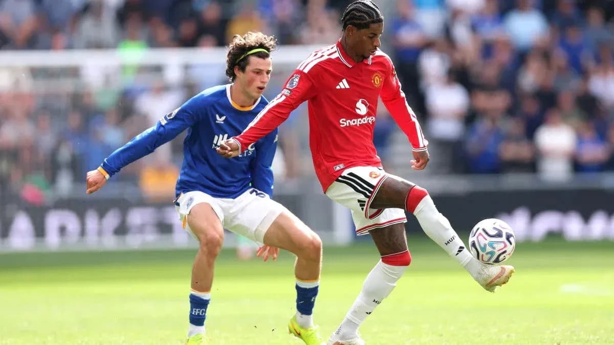 Manchester United player dribbling past opponent during match