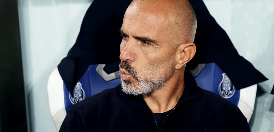 Coach seated on bench during match