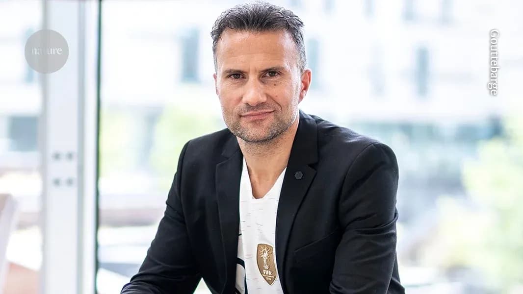 Man in black blazer sitting indoors