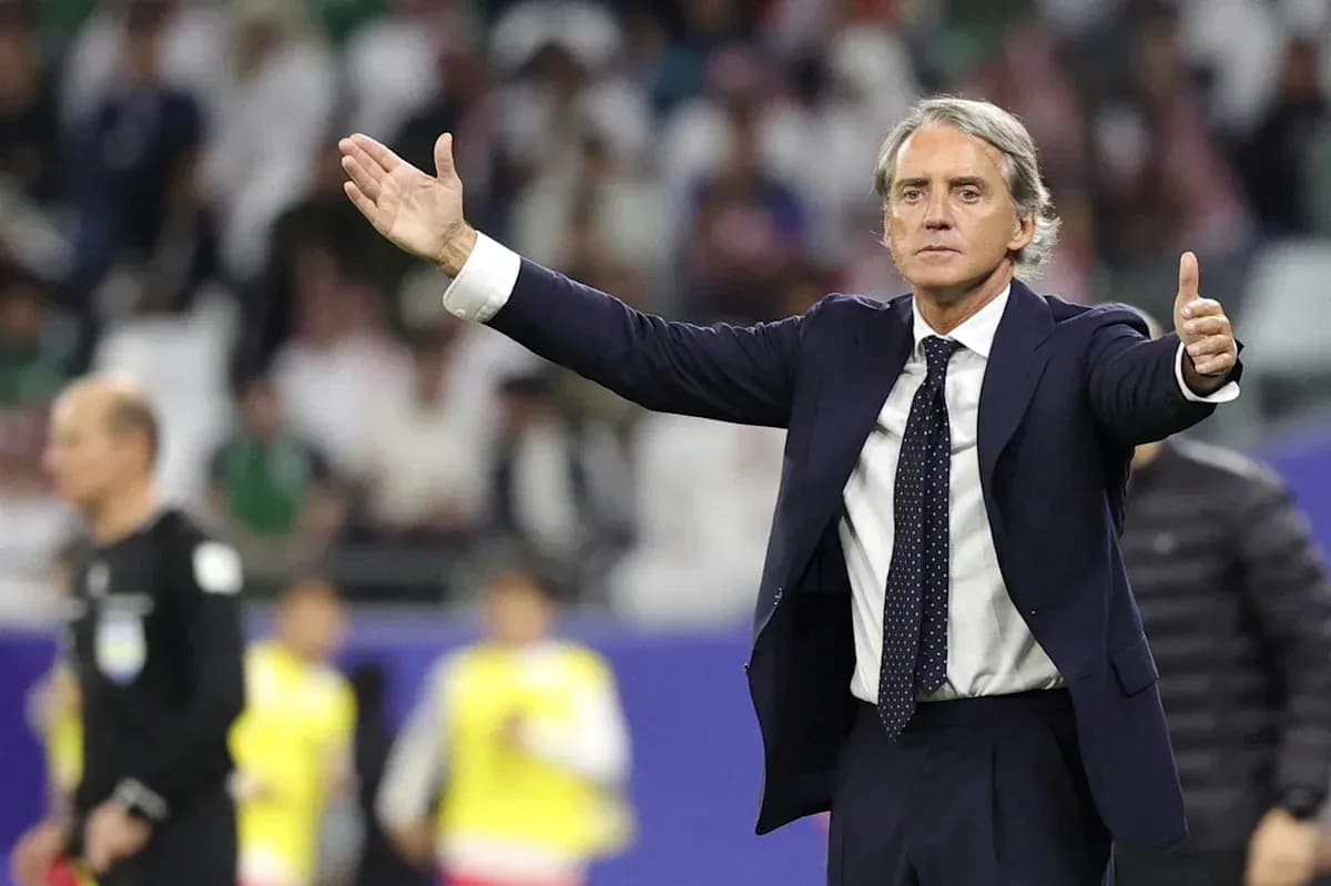 Coach gesturing during a football match on the sidelines