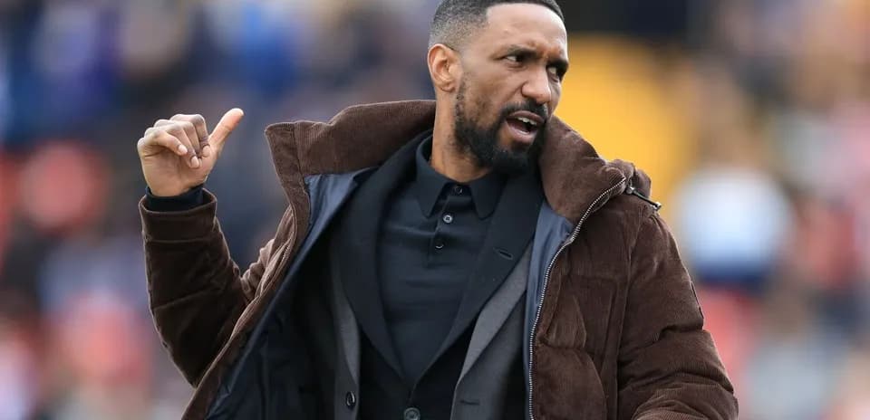 Coach gesturing during a match on the sidelines