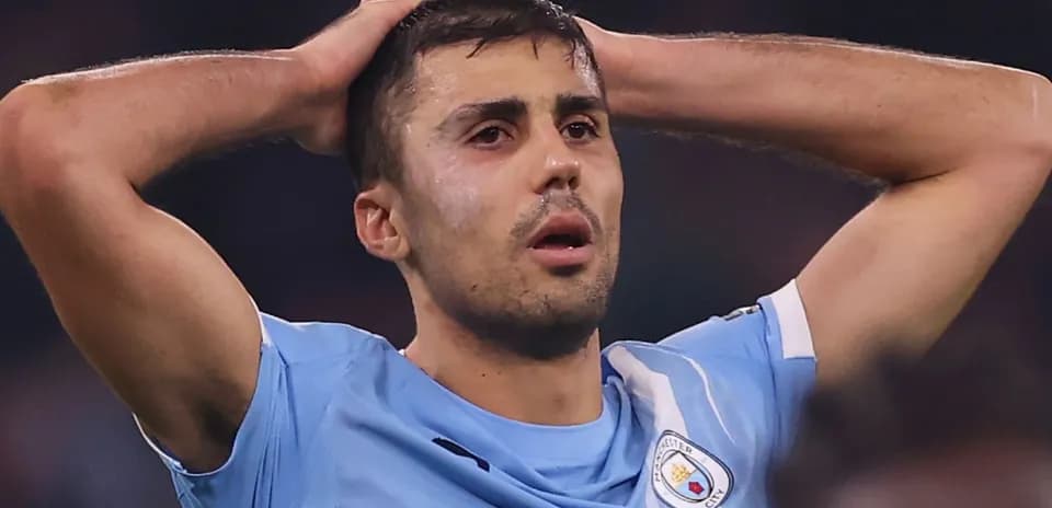 Manchester City player with hands on head in frustration