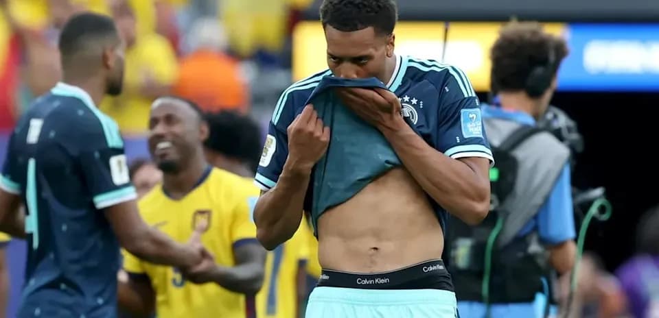 Player removing jersey after match with teammates