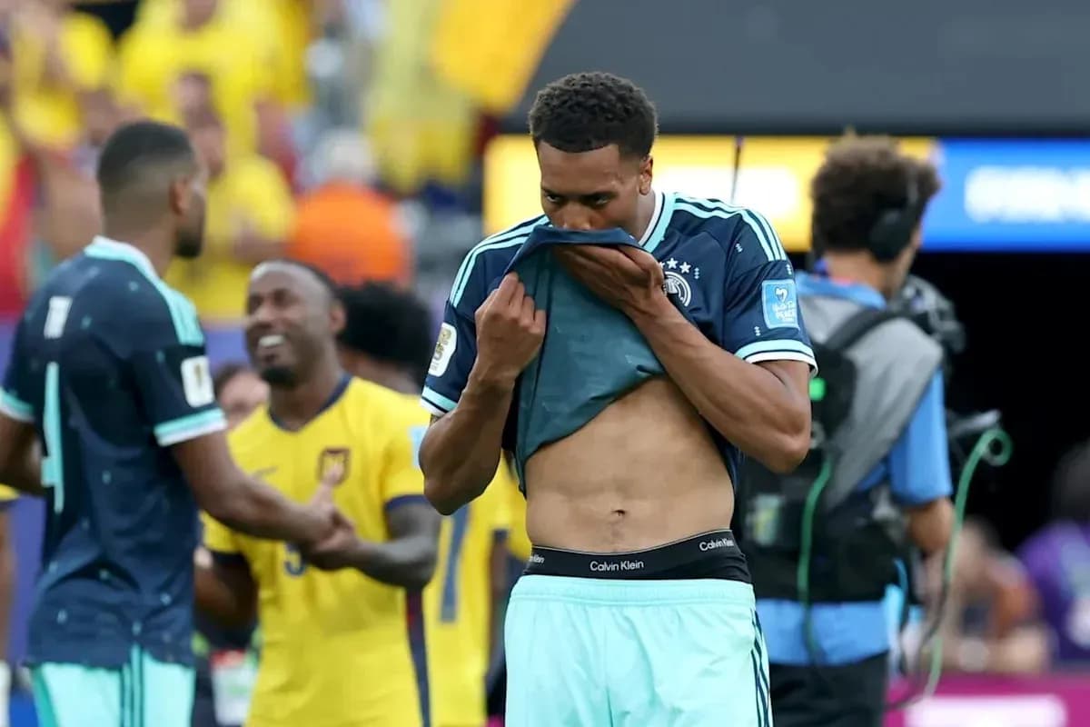 Player removing jersey after match with teammates