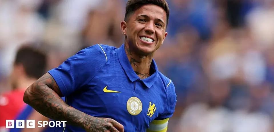 Player celebrating in blue kit with captain's armband