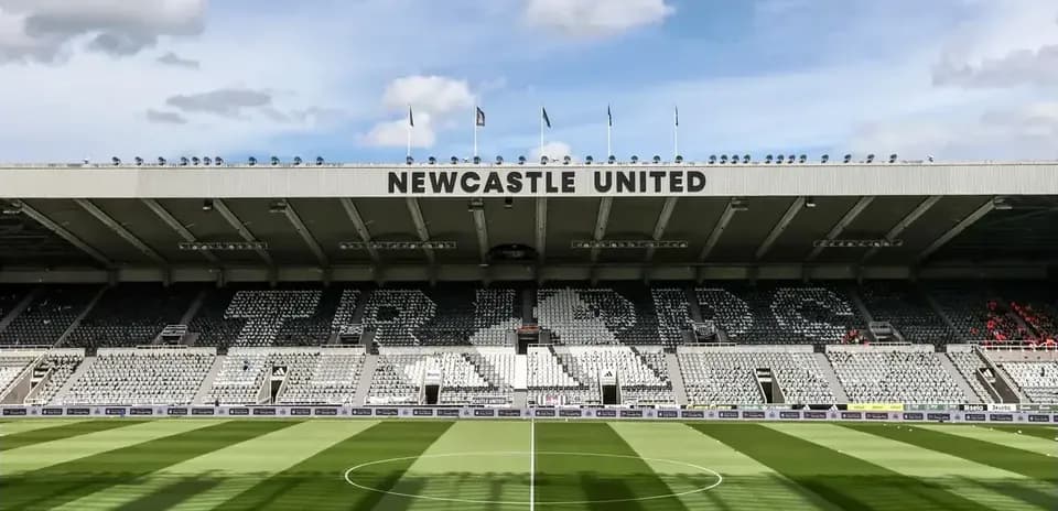 Stadium interior with Newcastle United signage and seating