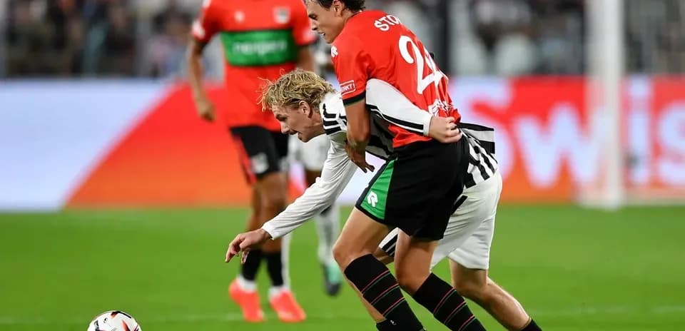Two players competing for the ball on the field