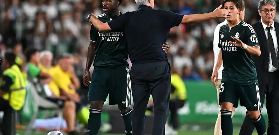 Coach instructing players during match substitution