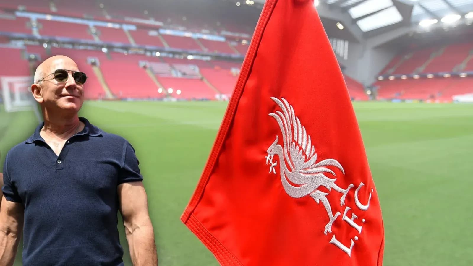 Man standing near Liverpool FC flag at stadium