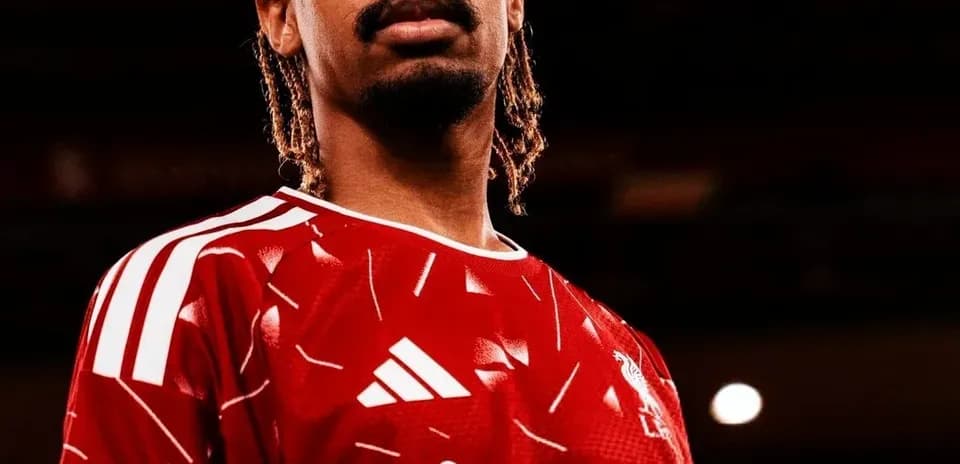 Player posing in Liverpool FC red jersey