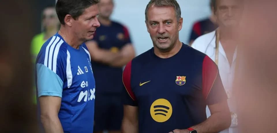 Coaches discussing during Barcelona training session