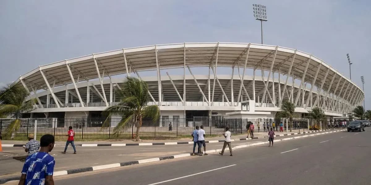 Exterior view of a modern stadium with pedestrians