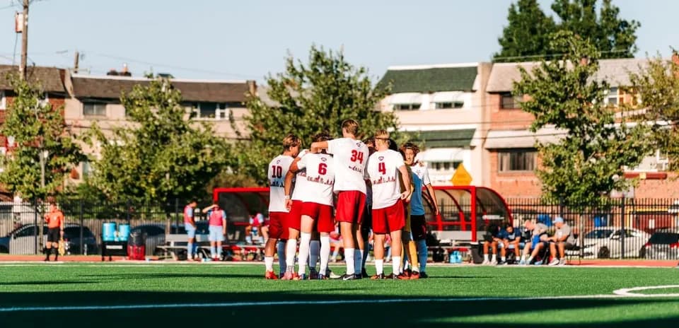 Team huddling before a soccer match on field