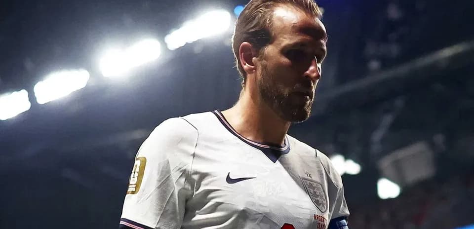 Player walking on pitch in England jersey