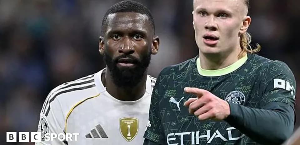 Two players in football kits on the pitch