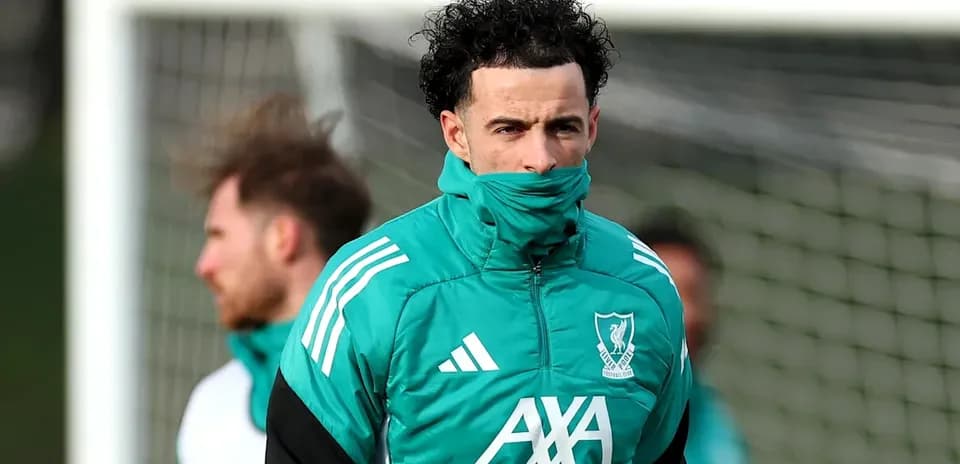 Player wearing Liverpool training kit on pitch