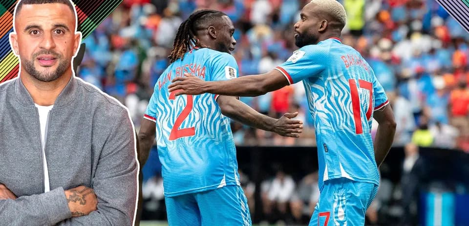 Players celebrating during a match, wearing blue kits
