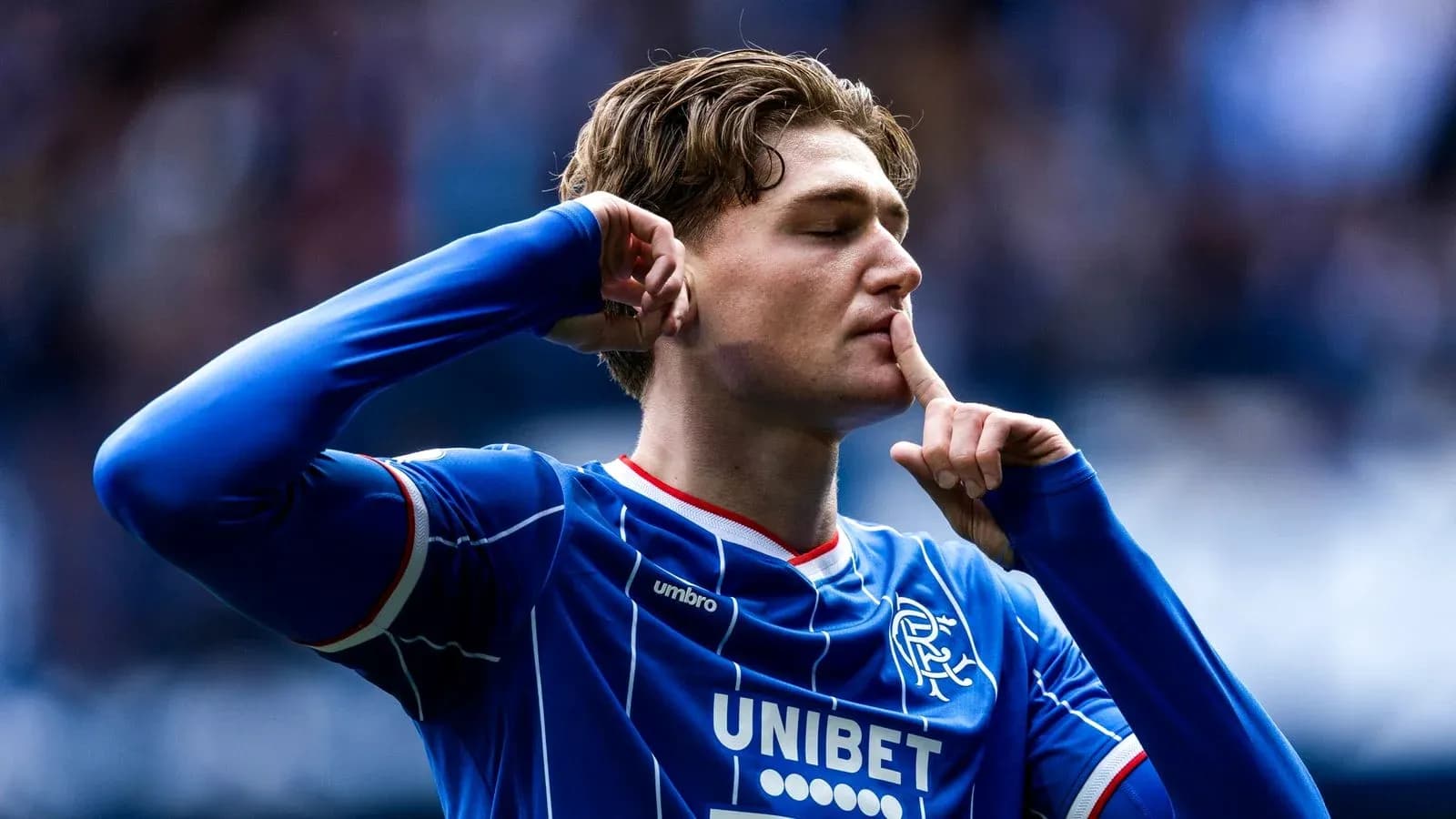 Player celebrating with shushing gesture after scoring