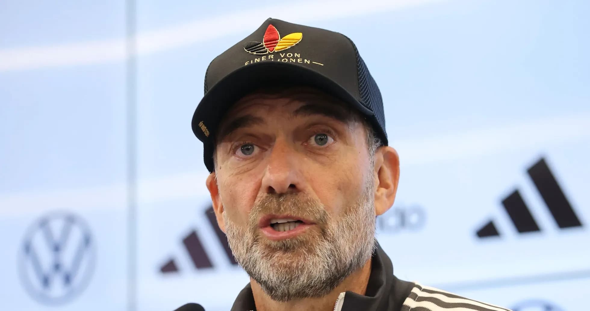 Manager speaking at press conference with microphone