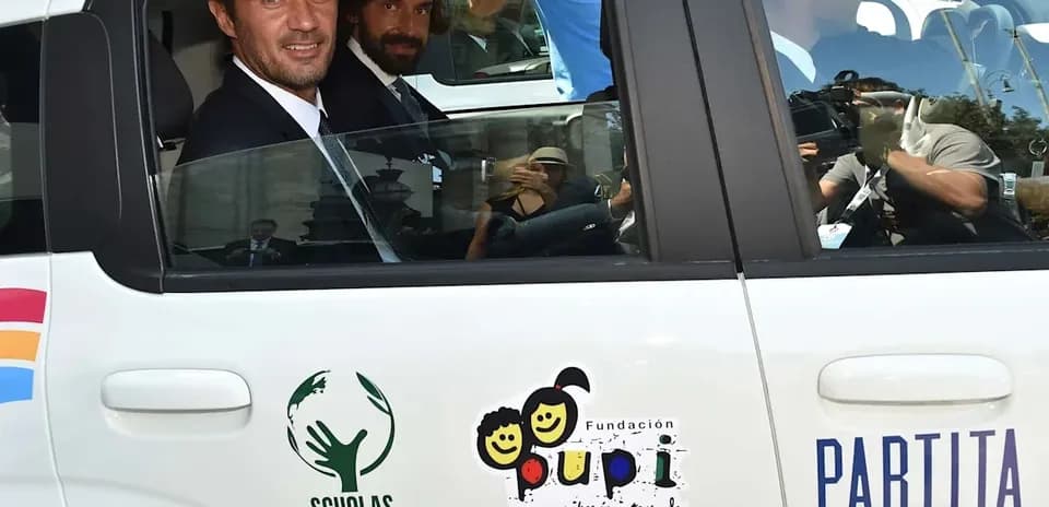 Two men sitting in a car with logos