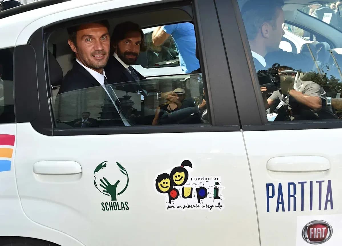 Two men sitting in a car with logos
