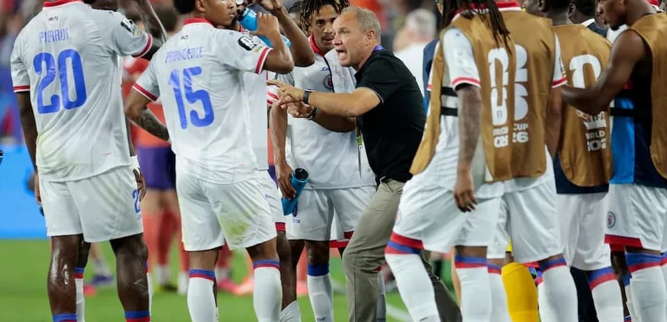 Haitian players discussing strategy during a match