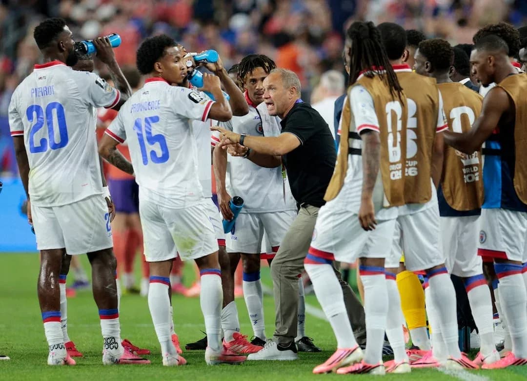 Haitian players discussing strategy during a match