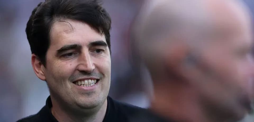 Man smiling during an event, blurred background