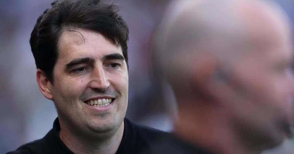 Man smiling during an event, blurred background