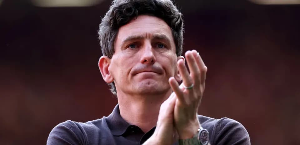Manager applauding during match at stadium