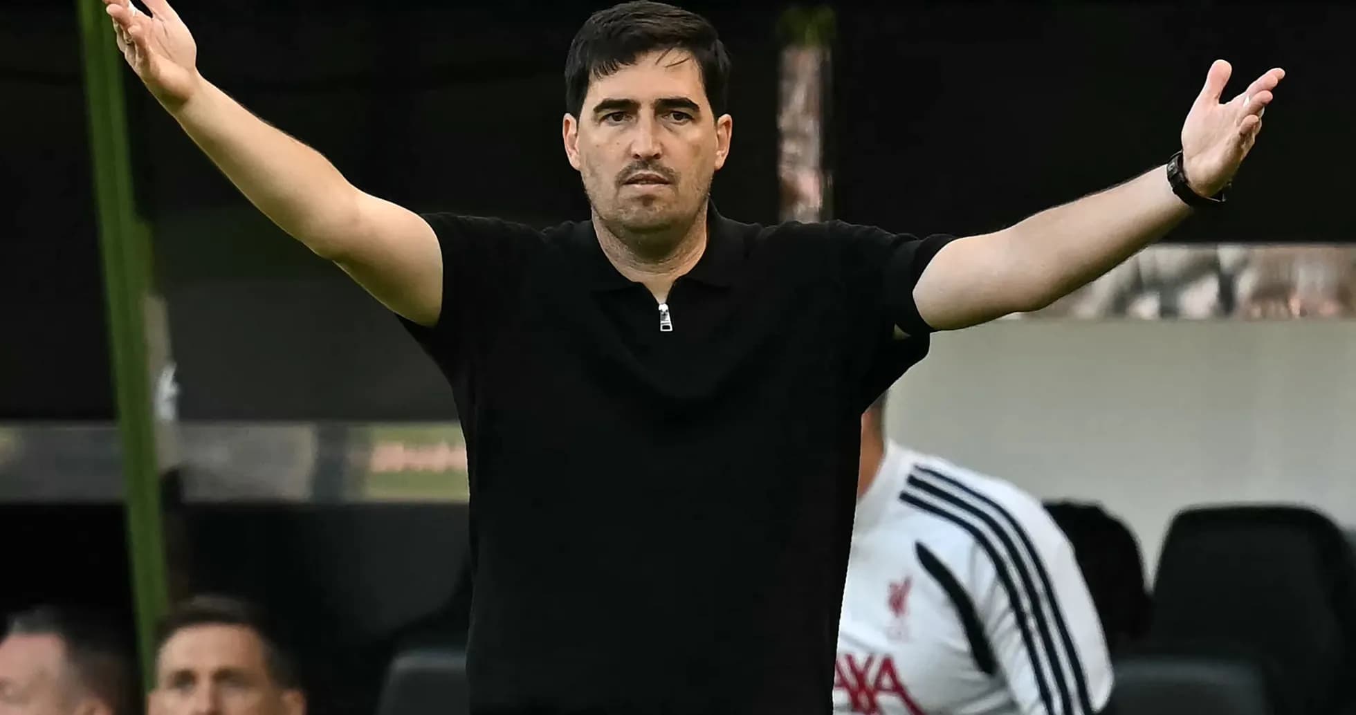 Coach gesturing during a match from the sideline