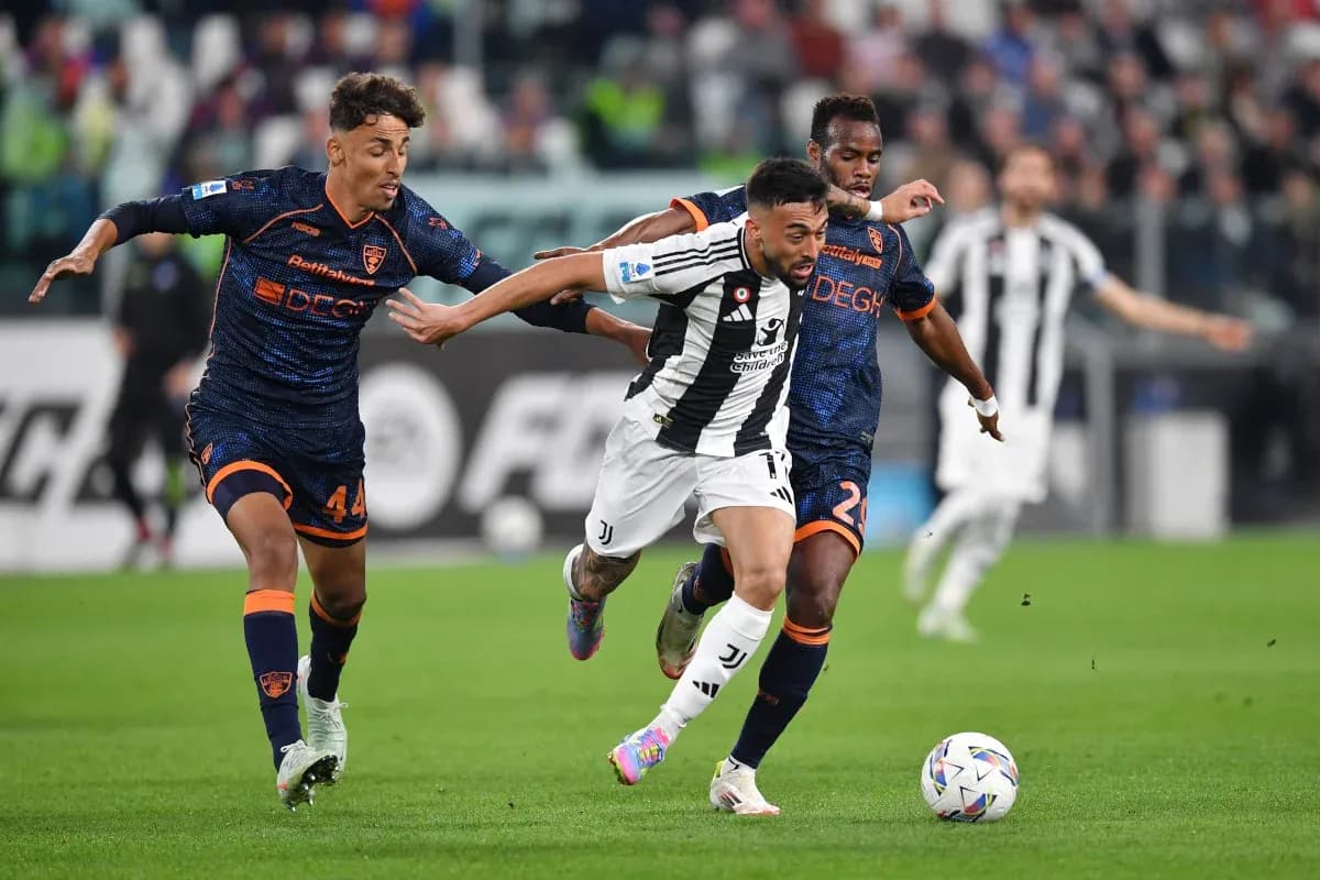 Juventus player evading Lecce defenders during match