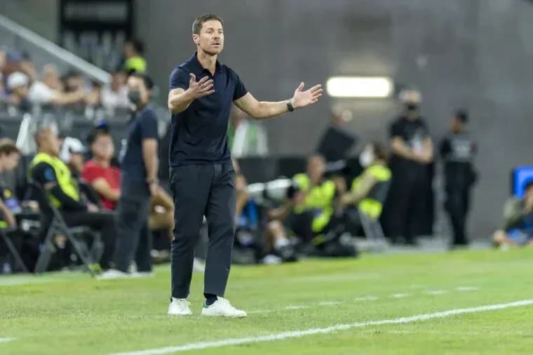 Coach gesturing on the sidelines during match