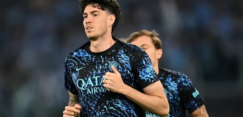 Player jogging in team training kit on pitch