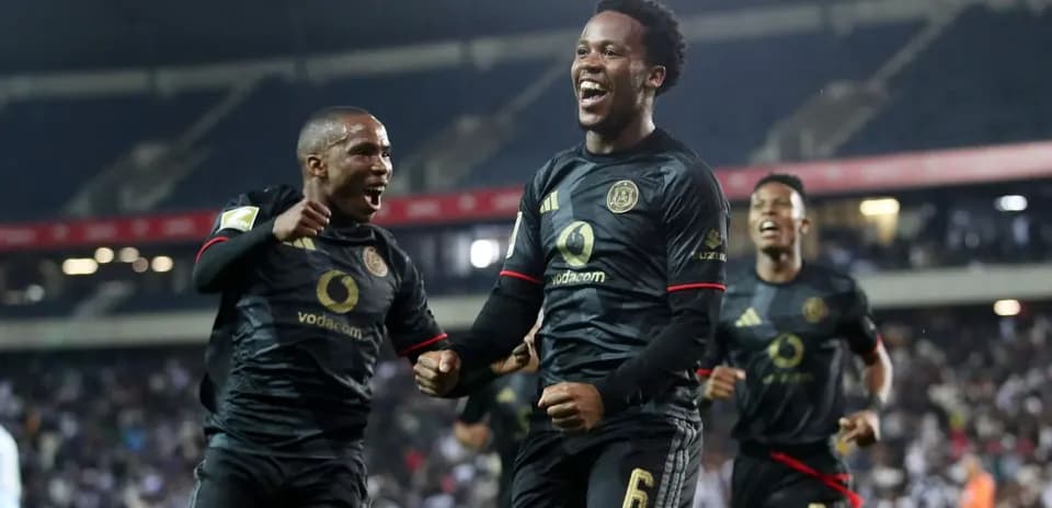 Players celebrating a goal in black jerseys