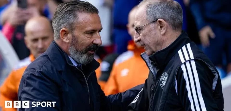 Two coaches shaking hands before a match