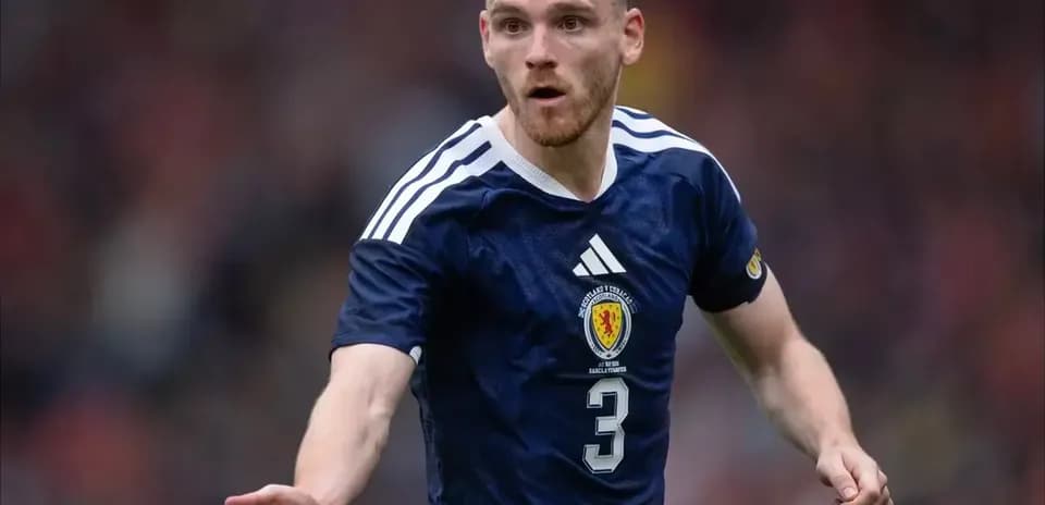 Player in Scotland kit during football match