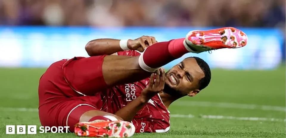 Player in red jersey injured on the ground